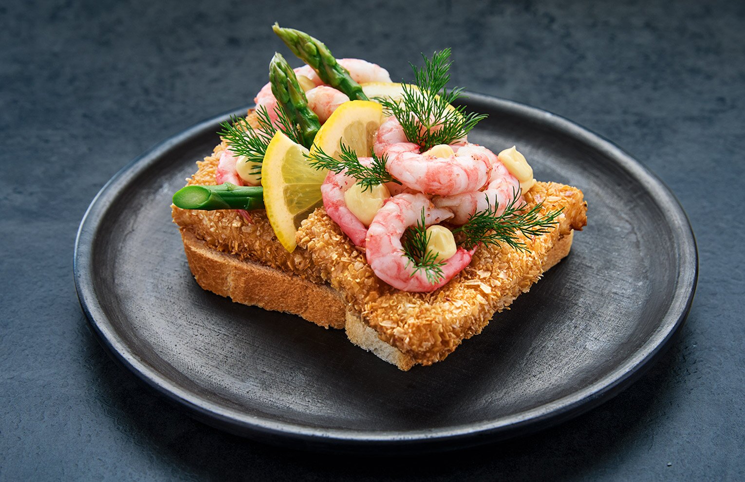 Pan-fried cod with prawns on white bread