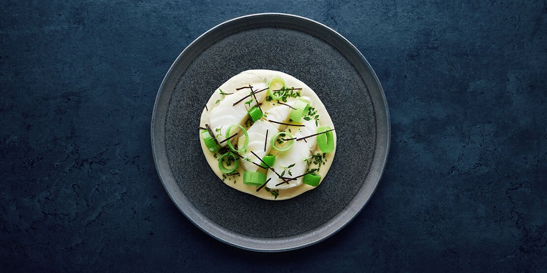 Baked skrei with potatoes, leek and truffle